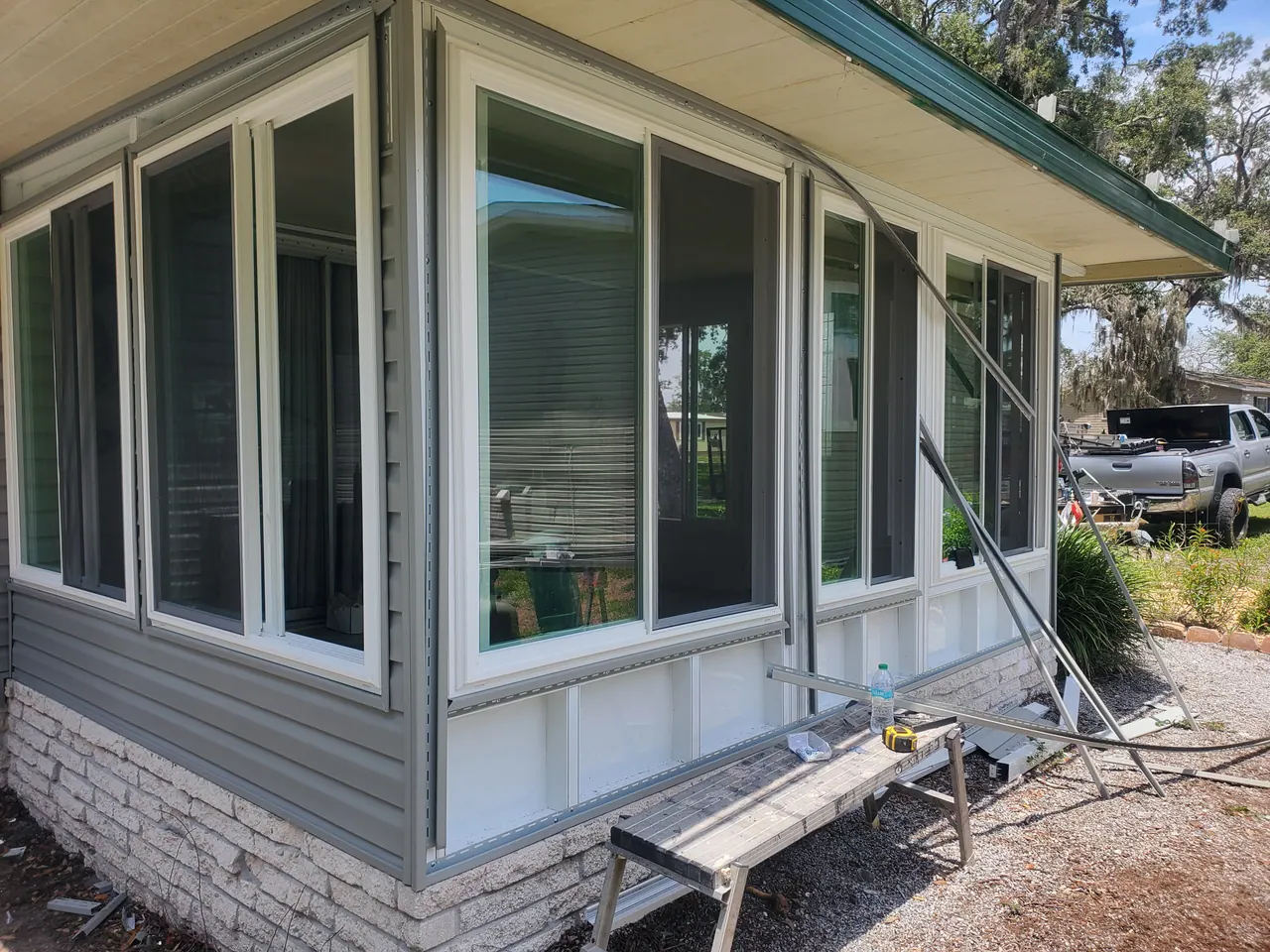 Exterior glazing, siding and the stone-faced base.