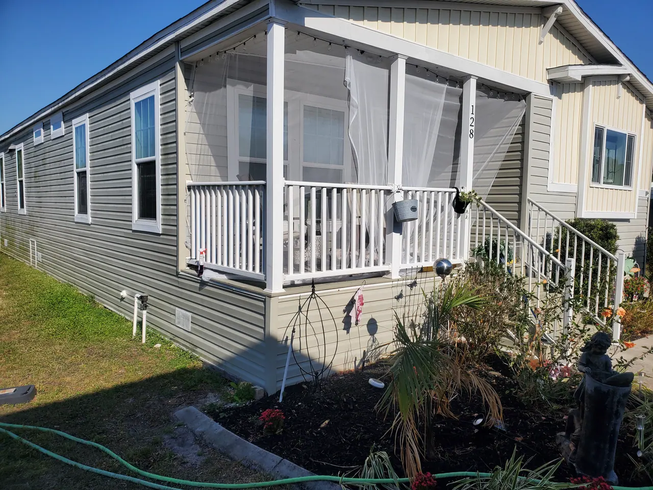 Grey horizontal siding and white window trim on a finished home exterior.