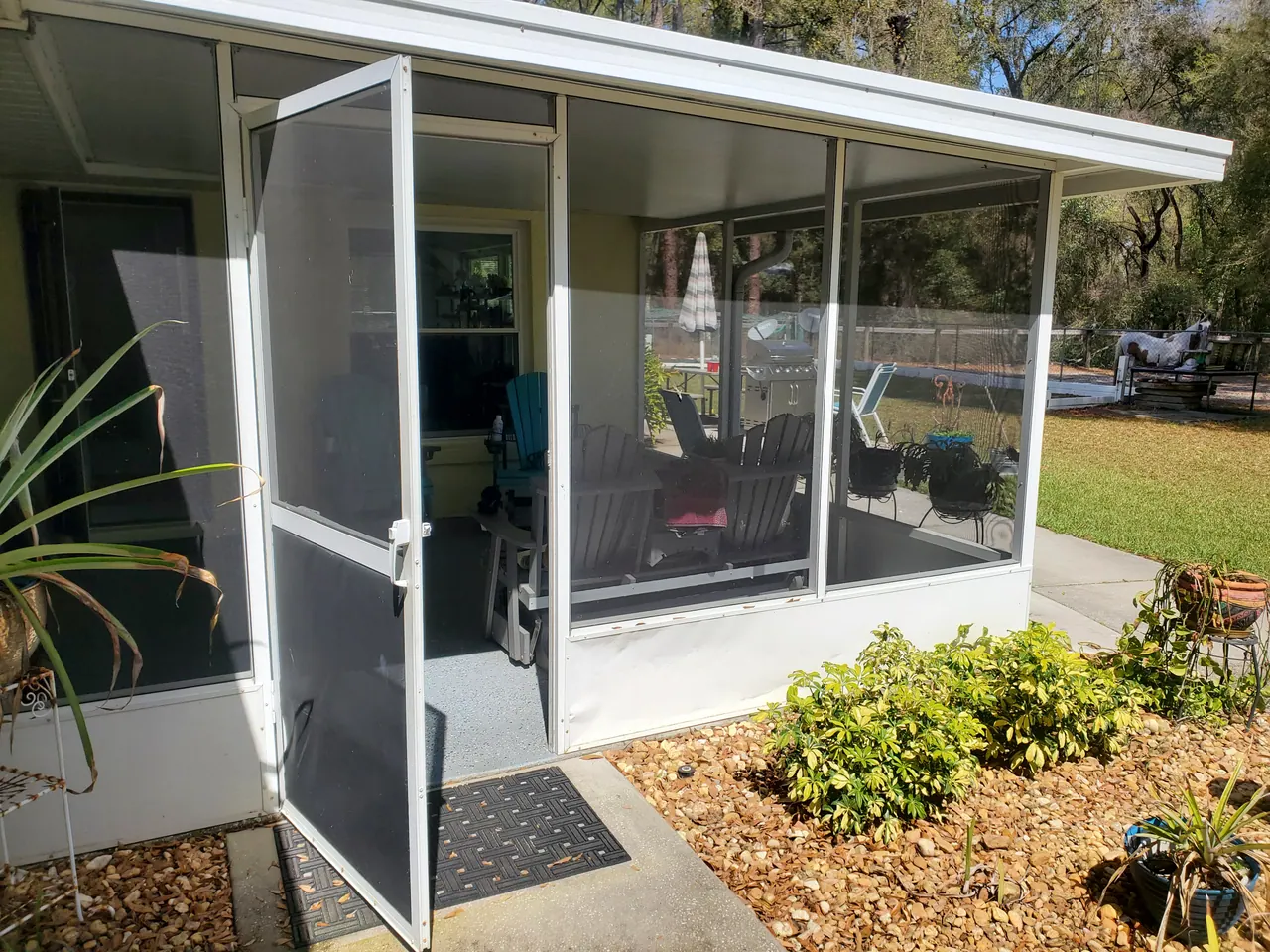 The screened patio entry and garden edge.